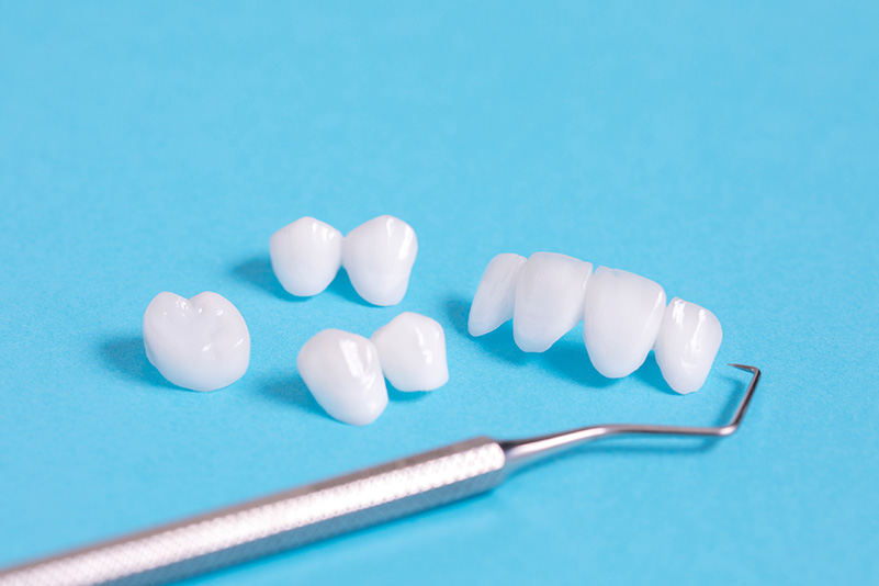 Dental explorer tool with zircon dentures on a blue sheet