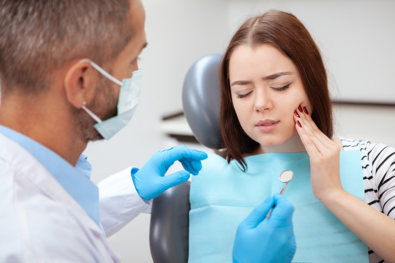 Beautiful young woman visiting dentist for medical checkup discussing sedation dentistry