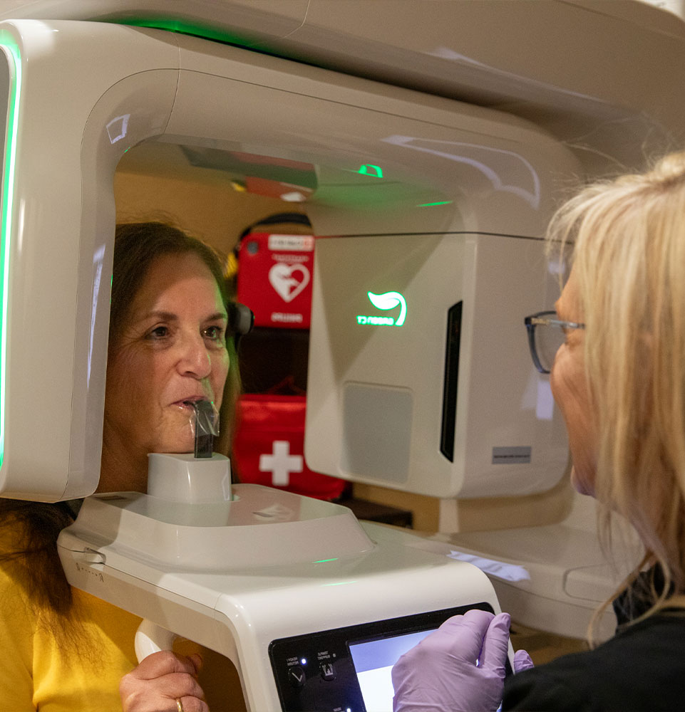 patient undergoing dental scanning with device inside of the dental practice for procedure