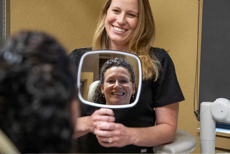 patient smiling after their dental procedure within the dental practice