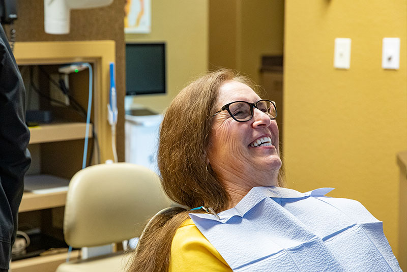 patient smiling while going through dental procedure