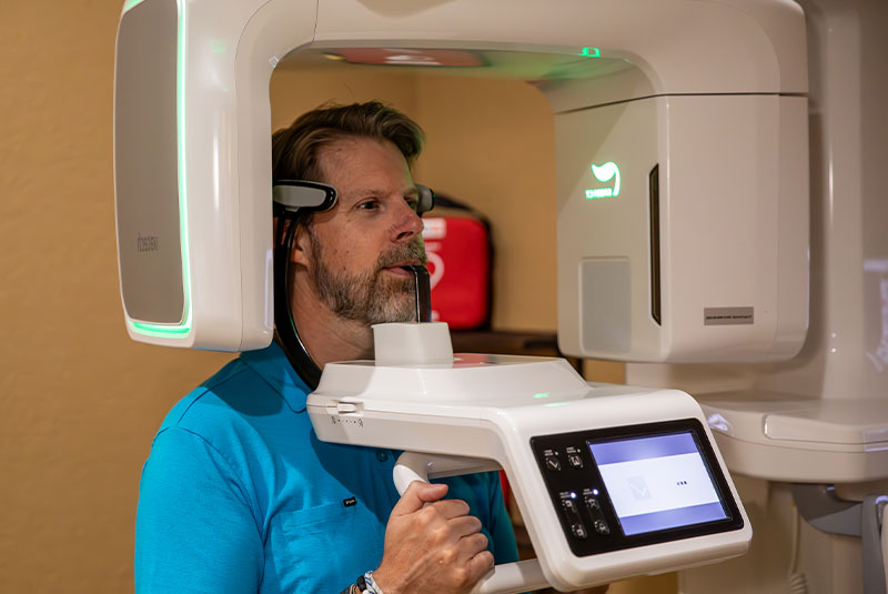 patient undergoing scanning with dental practice device for procedure